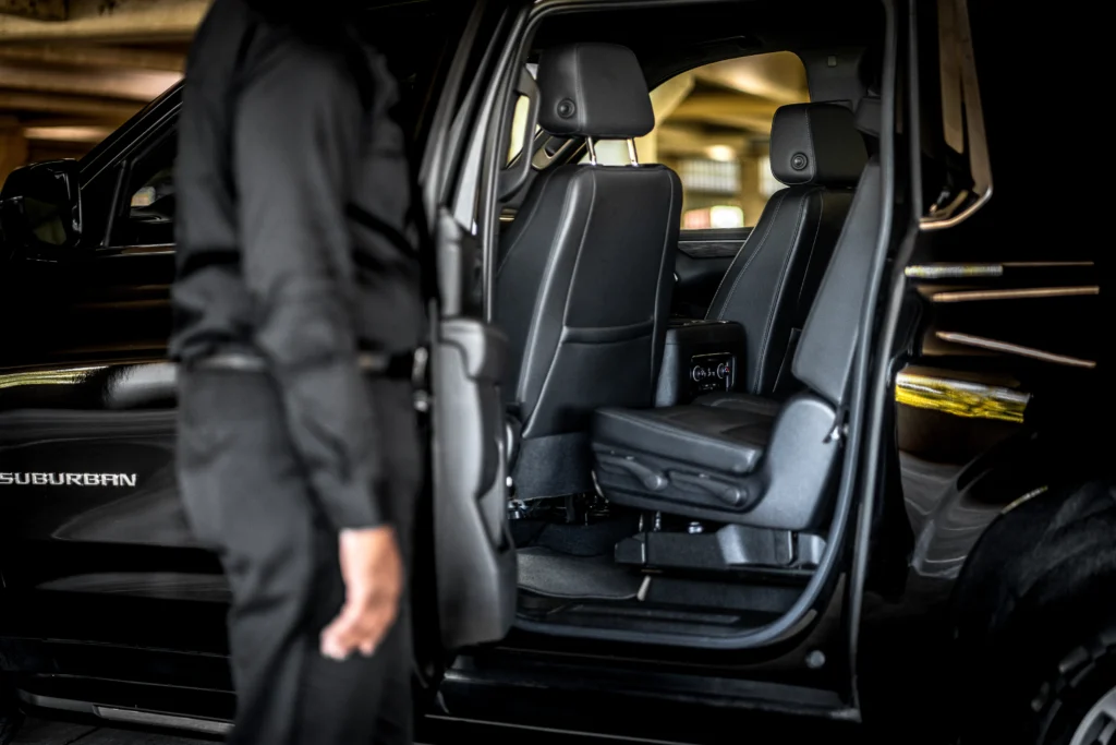Black SUV with an open passenger door showing leather seating