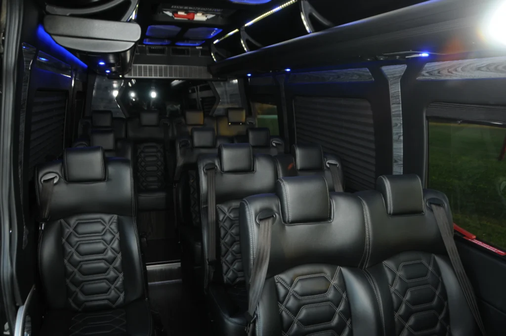 Sprinter passenger interior with black leather seats and blue ceiling lighting
