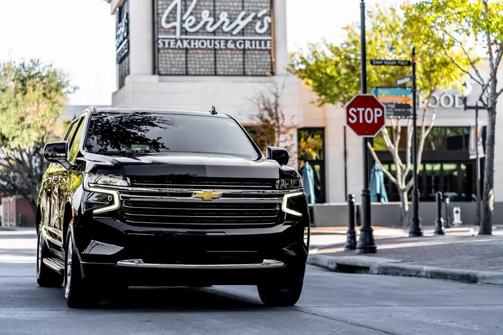Front view of a black Chevrolet Suburban on a city street