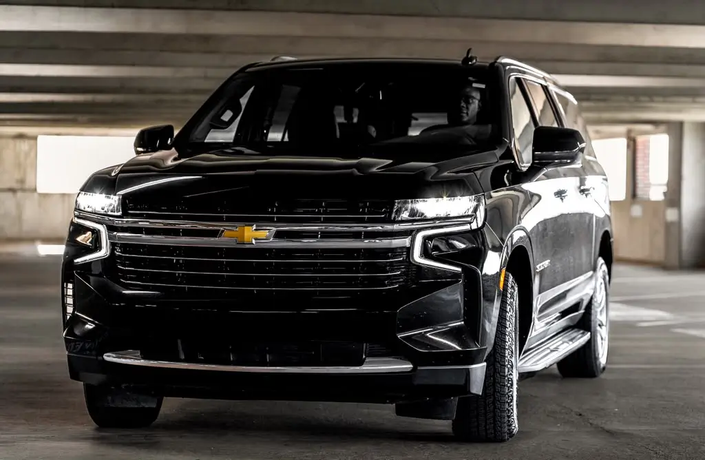 Black Chevrolet Suburban parked in a parking structure